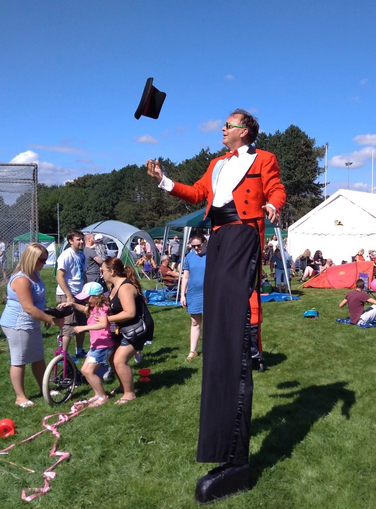 Mr Jules hat tricks on stilts on a hot day